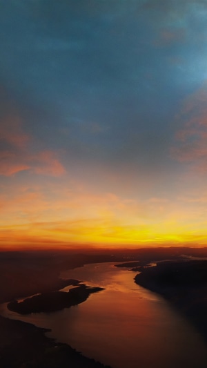 Sunset over a winding river with clouds