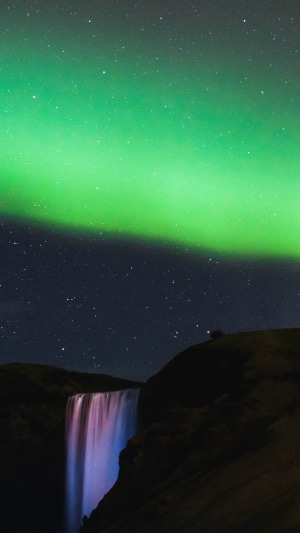 Aurora Borealis over a waterfall in Iceland