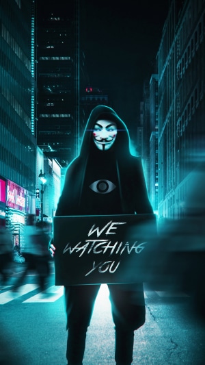 Anonymous figure with 'We are watching you' sign