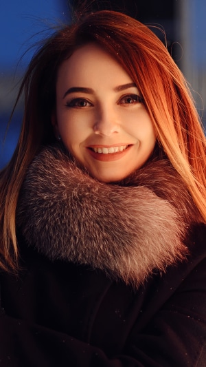 Young woman with red hair smiling