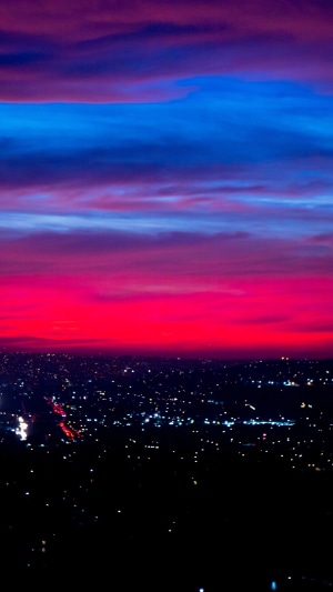 City lights at sunset with colorful clouds
