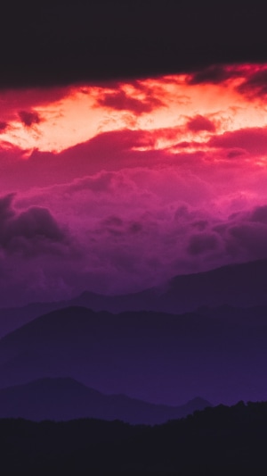 Dramatic sunset clouds over silhouetted mountains