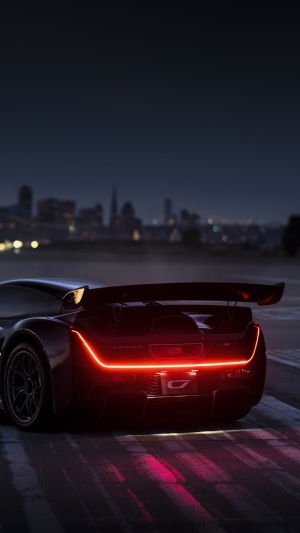 Ciznger 21C hypercar at night with city skyline