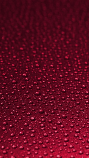 Red surface with water drops texture