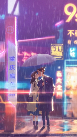 Couple kissing under umbrella in rainy city at night