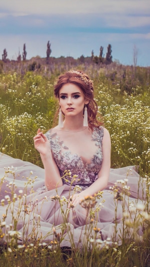 Model in a dress in a field of flowers