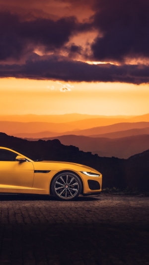 Yellow Jaguar F-Type car at sunset