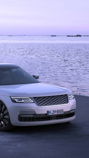 White Range Rover parked by the water