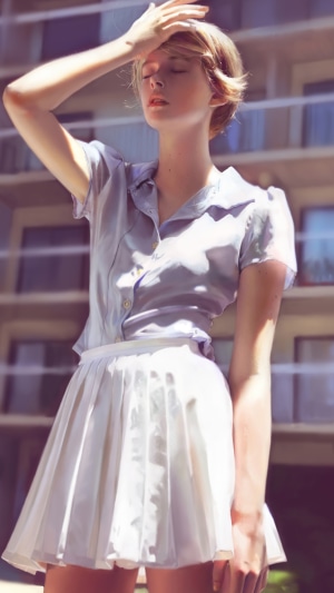 Woman in a light blue shirt and white skirt