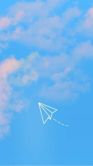 Paper airplane flying in a blue sky with clouds
