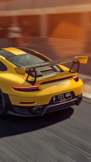 Yellow Porsche GT2 RS on a race track