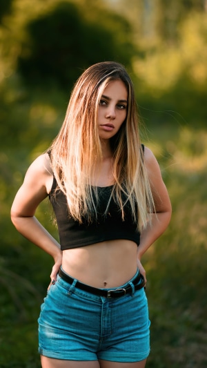 Blonde girl in crop top and denim shorts