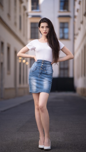 Woman in white t-shirt and denim skirt