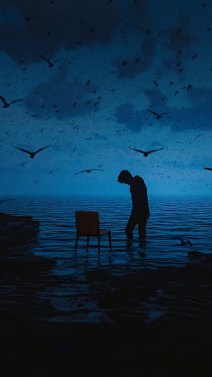 Man standing in water with chair and birds