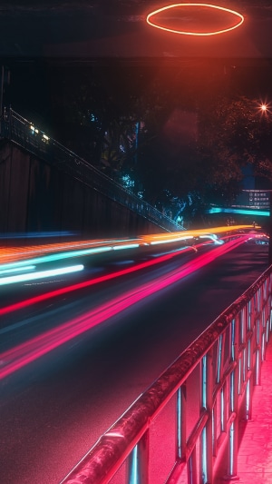 Long exposure photography of a road at night with light trails