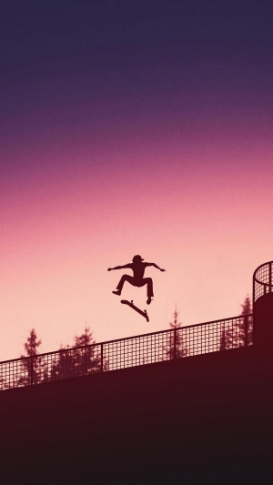Skateboarder performing a trick at sunset