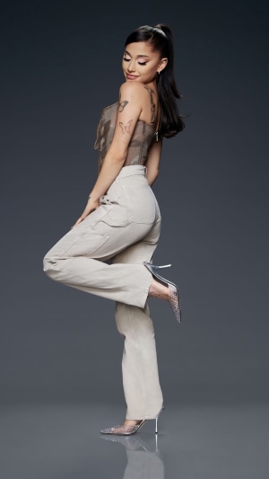 Ariana Grande in beige pants and a corset top