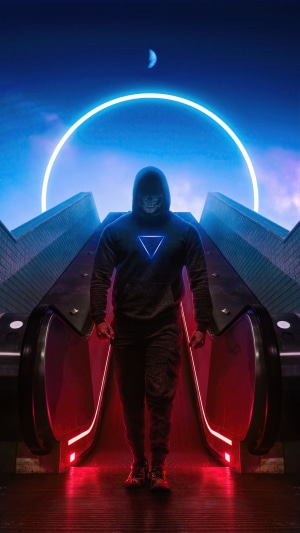 Man in hoodie with triangle logo on escalator