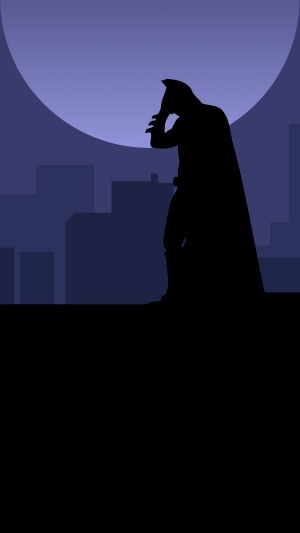 Batman silhouette against a large moon and city skyline