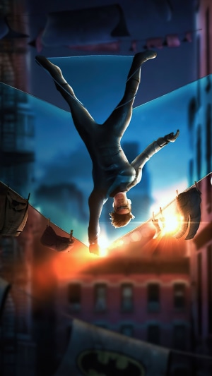 Nightwing performing a handstand on a clothesline