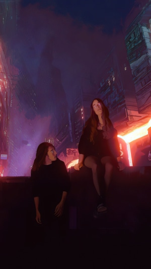 Two people in a futuristic city at night