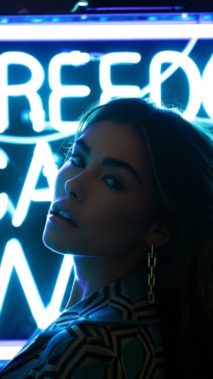 Madison Beer in front of neon sign
