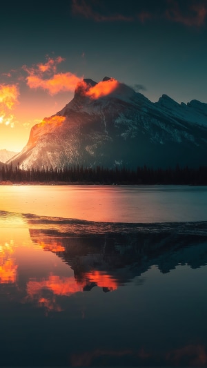 Mountain reflecting in lake at sunrise 4K