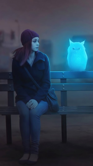 Girl with a glowing owl on a bench