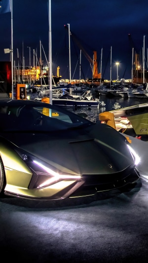 Lamborghini Sian parked at a harbor at night