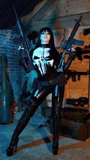 Cosplayer dressed as The Punisher with guns