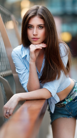 Model in striped shirt and denim shorts