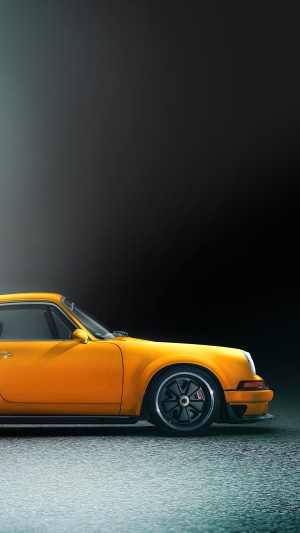 Yellow Porsche 911 Singer on a wet surface