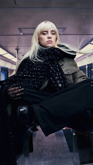 Billie Eilish sitting on a subway train