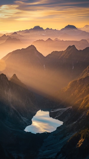 Mountain range with lake at sunrise, 4K