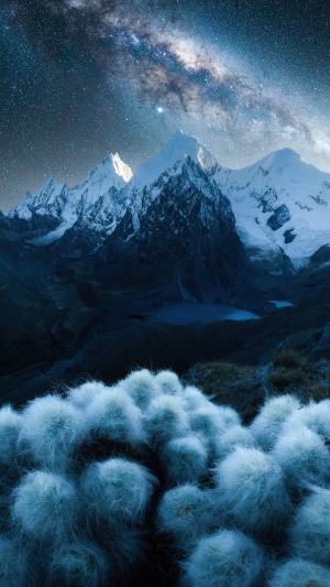Snowy mountains under the Milky Way at night