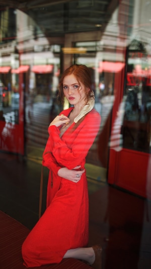 Redhead model in red dress