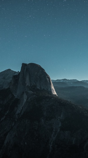 Half Dome mountain under starry night sky