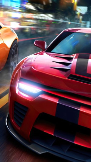 Red and orange sports cars racing on a city street at night