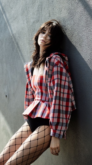 Kendall Jenner in plaid jacket and fishnet stockings