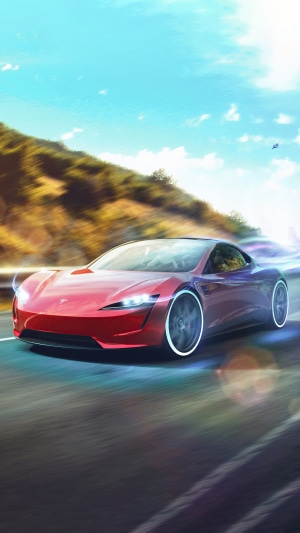 Red Tesla Roadster driving on a road