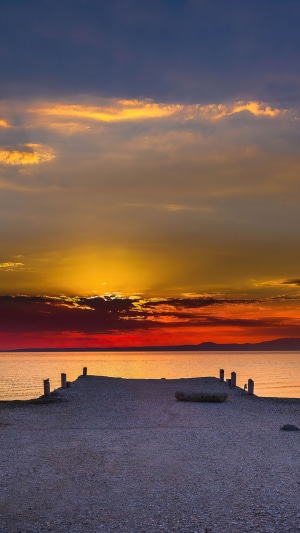 Pier at sunset over the ocean