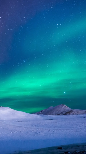 Aurora Borealis over snowy mountains 4K