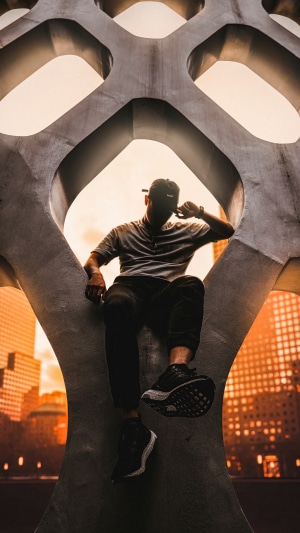 Man sitting on concrete structure 4K