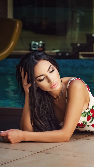Model in floral dress by the pool
