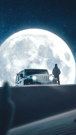 Jeep on a sand dune under the moon