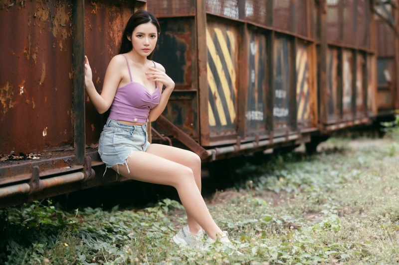 Asian woman sitting on a train car
