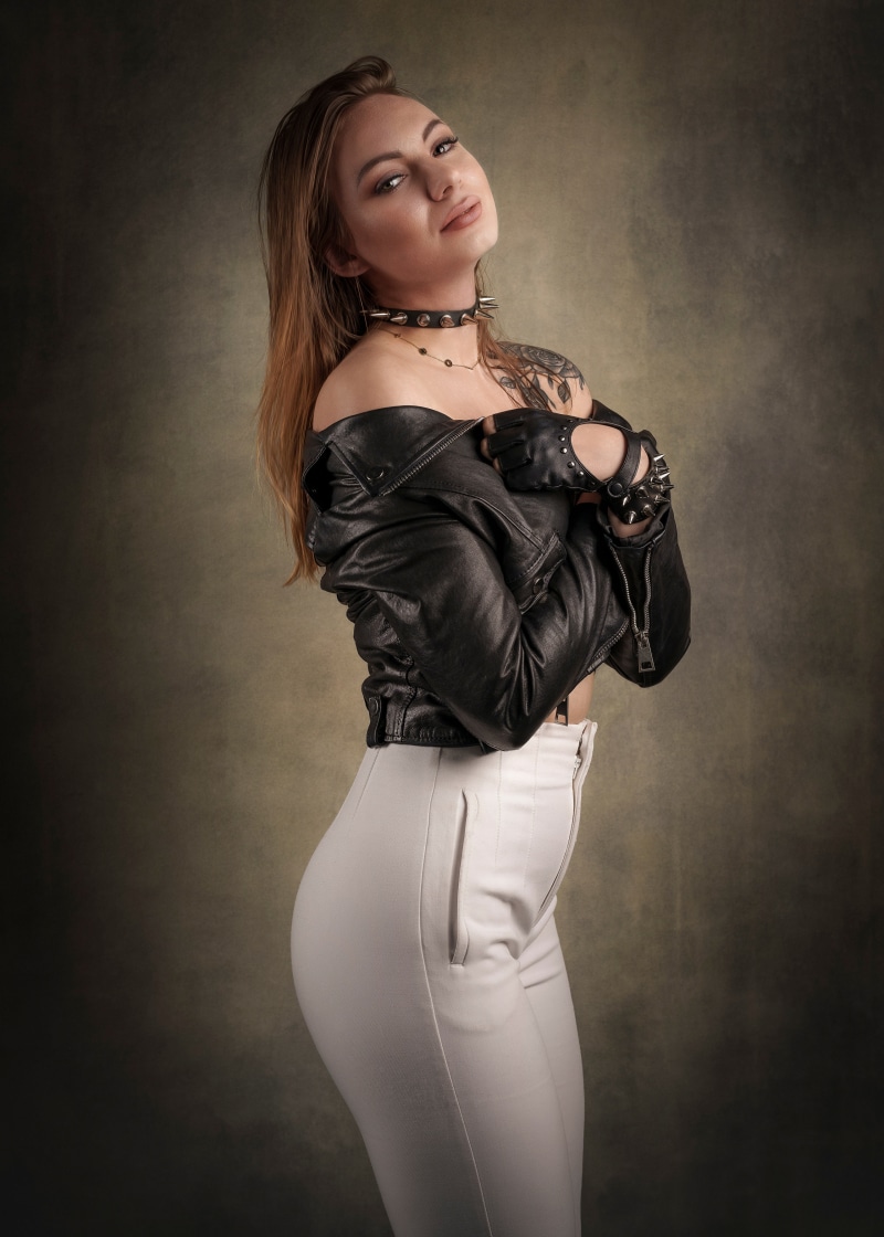Woman in leather jacket and white trousers