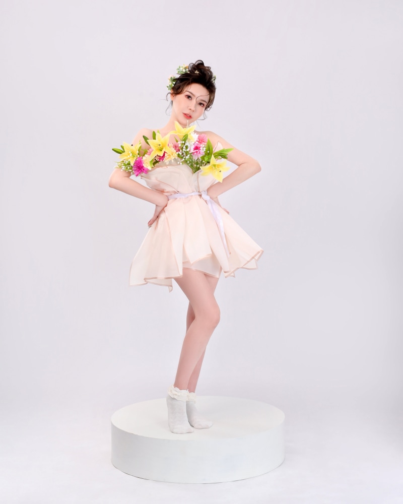 Asian woman in a dress holding flowers