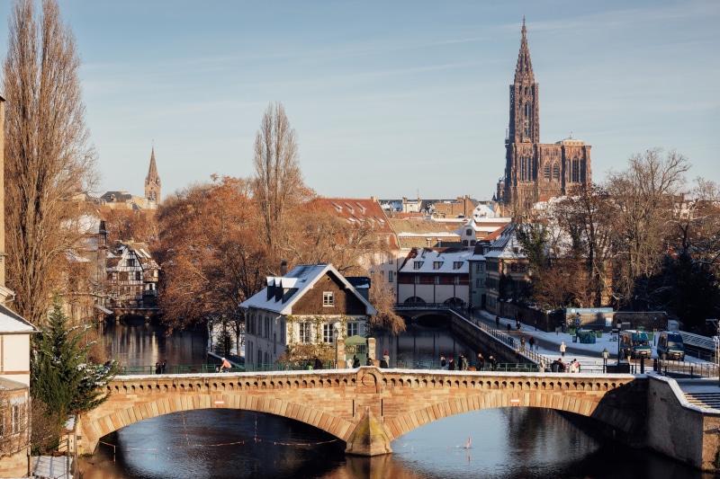 Strasbourg Cathedral and bridge over river in winter