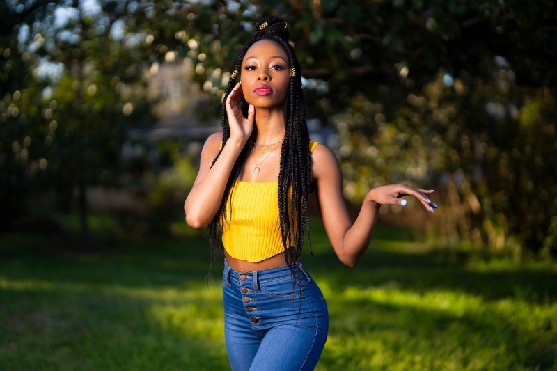 Janae Fulton posing in yellow top and jeans